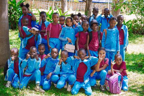 Older pupils posing together beneath the trees